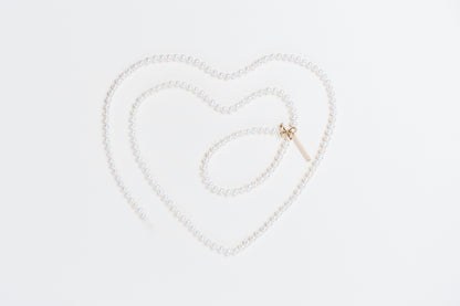 Akoya pearl necklace with diamond pave ribbon clasp